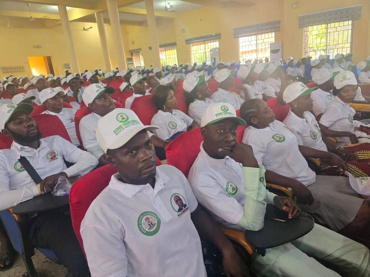 Trainees seated in a packed training hall